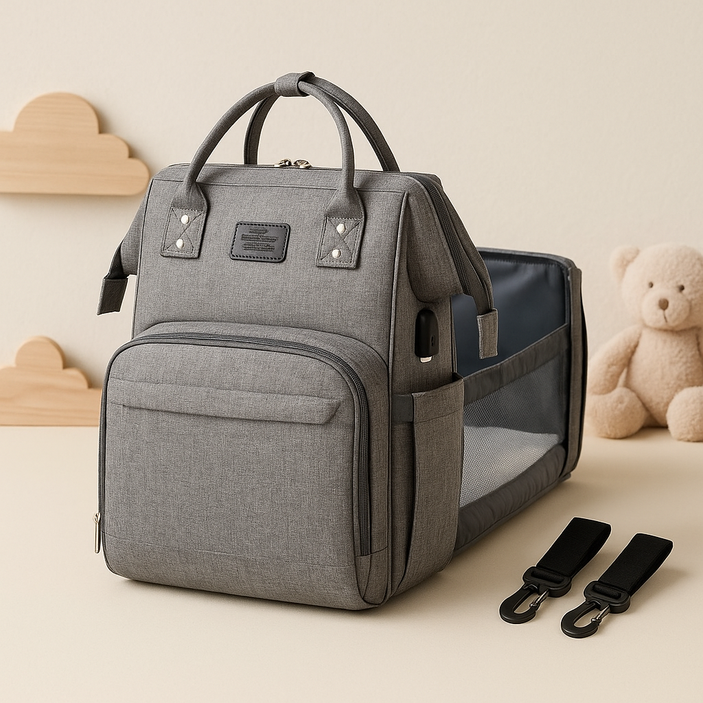 Grey multifunctional baby diaper bag with built-in foldable bassinet.