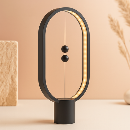 Modern black balance lamp with warm light on a beige background