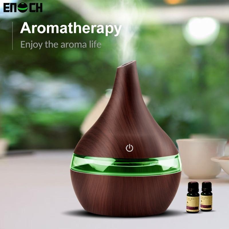 Wooden aromatherapy diffuser with green light on a blurred natural background