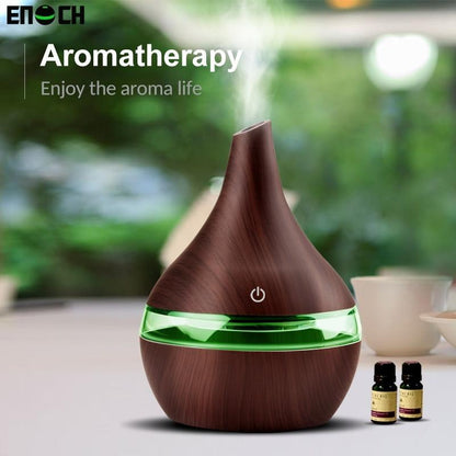 Wooden aromatherapy diffuser with green light on a blurred natural background